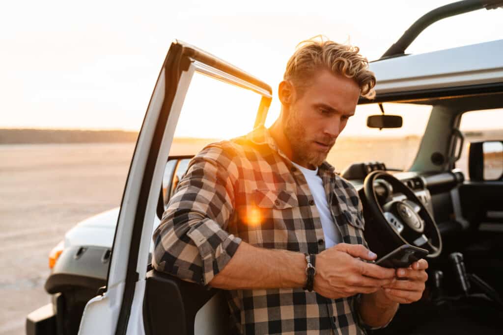 Handsome young man using mobile phone